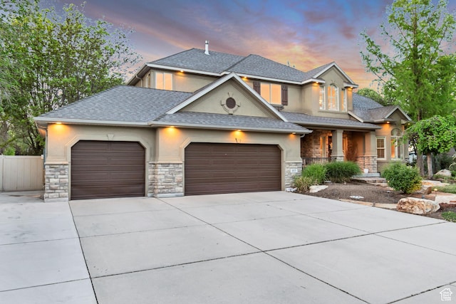 view of front of home featuring stucco siding, an attached garage, stone siding, concrete driveway, and a porch