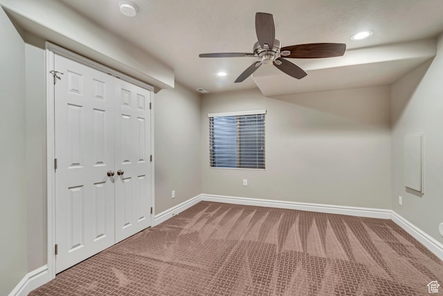 unfurnished bedroom featuring carpet floors, baseboards, recessed lighting, a closet, and a ceiling fan