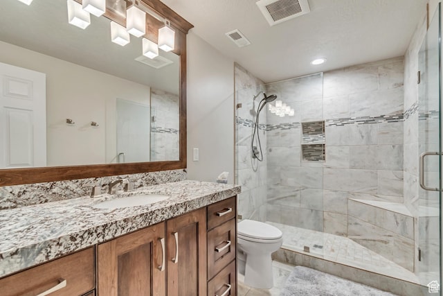 full bathroom featuring a stall shower, vanity, toilet, and recessed lighting