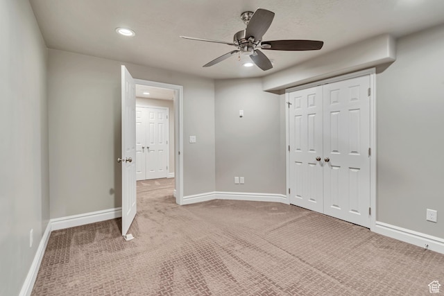 unfurnished bedroom with recessed lighting, carpet flooring, baseboards, a ceiling fan, and a closet