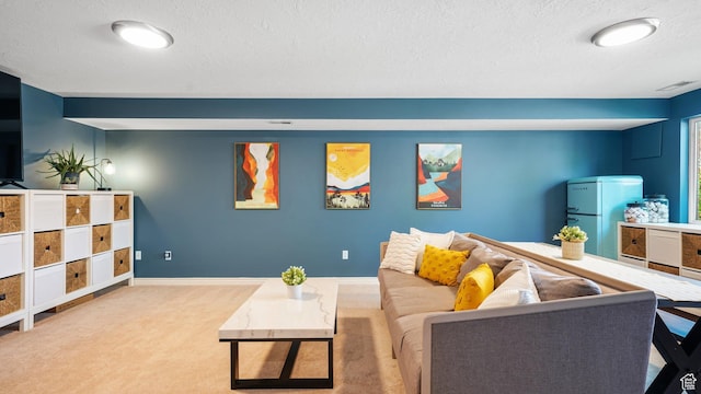 carpeted living area featuring a textured ceiling and baseboards
