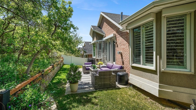 view of side of home featuring a fenced backyard, a patio area, and outdoor lounge area