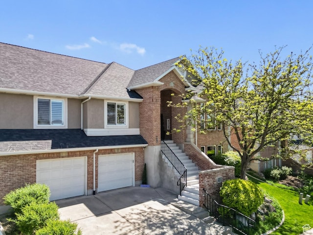426 E Brayden Way, Draper, UT 84020 - view of front of house featuring driveway, stucco siding, a garage, roof with shingles, and stairway