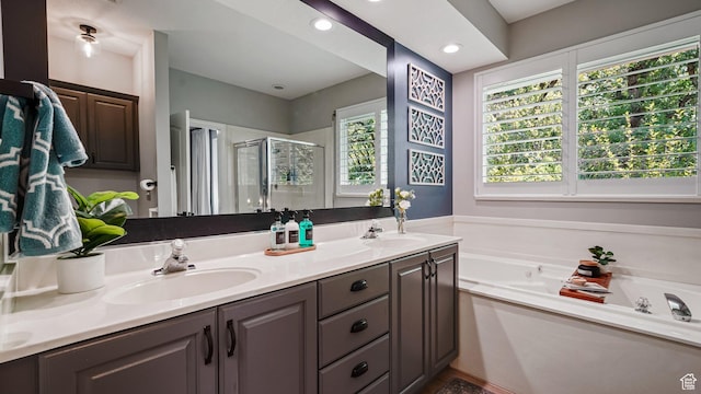 full bath featuring a stall shower, double vanity, a garden tub, and recessed lighting