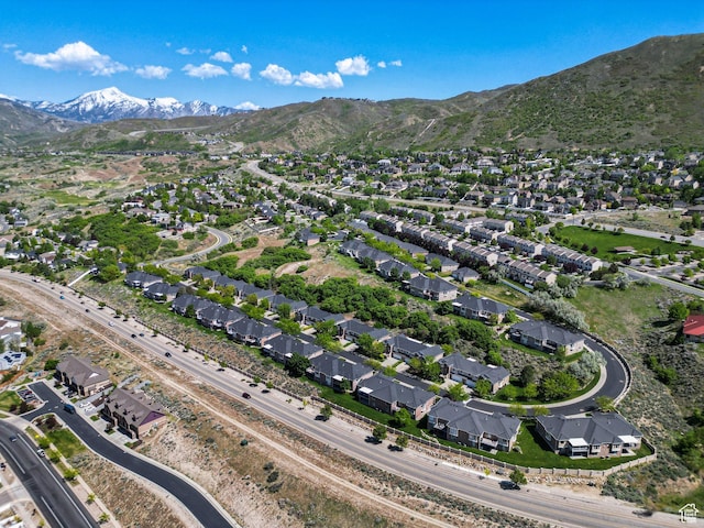aerial overview of property's location with a mountain backdrop and nearby suburban area