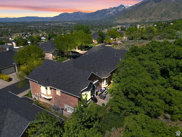 aerial view of property and surrounding area featuring a mountainous background