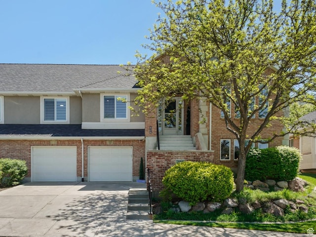426 E Brayden Way, Draper, UT 84020 - view of front facade featuring driveway, an attached garage, stucco siding, roof with shingles, and brick siding