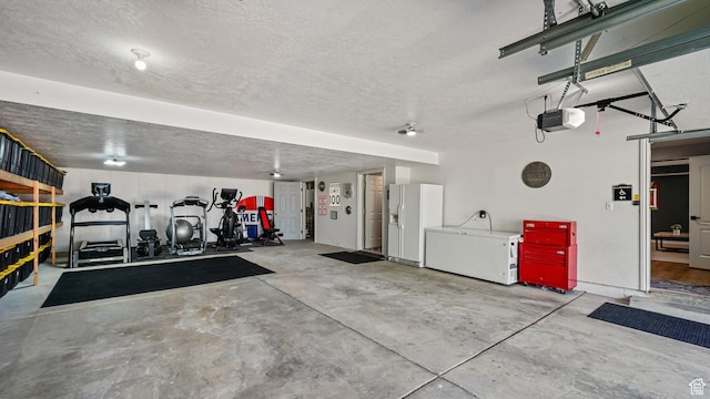 garage with white fridge with ice dispenser and a garage door opener