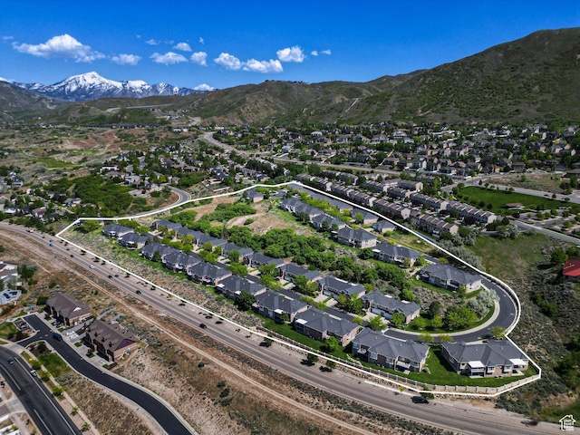 aerial view of property and surrounding area with nearby suburban area and a mountainous background