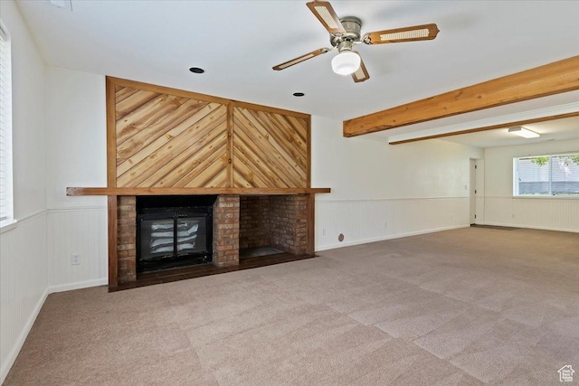 754 W 2100 N, Provo, UT 84604 - unfurnished living room featuring carpet flooring, a brick fireplace, a ceiling fan, beamed ceiling, and wainscoting