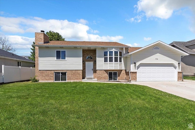 754 W 2100 N, Provo, UT 84604 - bi-level home with brick siding, concrete driveway, a chimney, and a garage