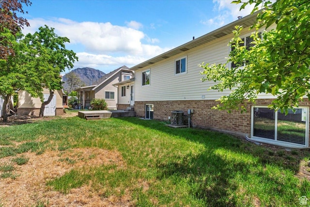 754 W 2100 N, Provo, UT 84604 - rear view of house featuring brick siding, a mountain view, a lawn, and central air condition unit