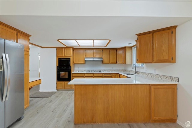 754 W 2100 N, Provo, UT 84604 - kitchen with black appliances, under cabinet range hood, a sink, light countertops, and a peninsula