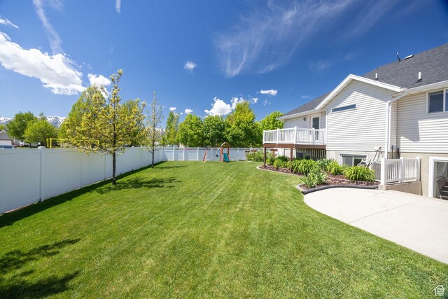 view of yard featuring a patio area and a deck