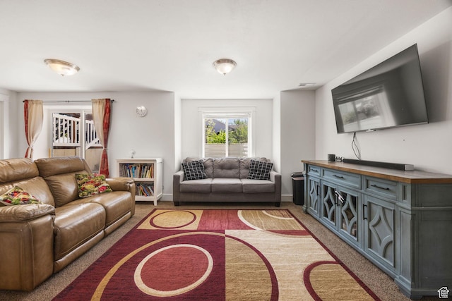 carpeted living room featuring baseboards