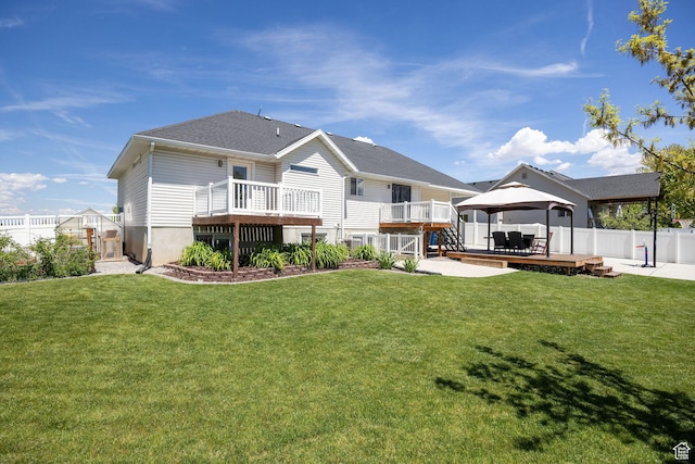 rear view of house with a gazebo and a wooden deck
