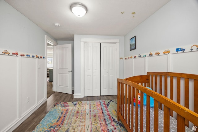 bedroom featuring a closet and dark wood-style floors