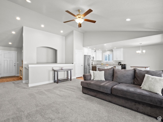 living room with a ceiling fan, a chandelier, recessed lighting, light colored carpet, and baseboards