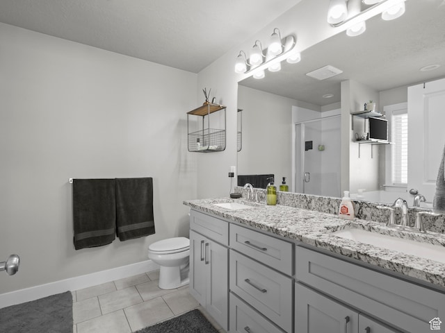 full bathroom with a shower stall, tile patterned floors, toilet, double vanity, and baseboards