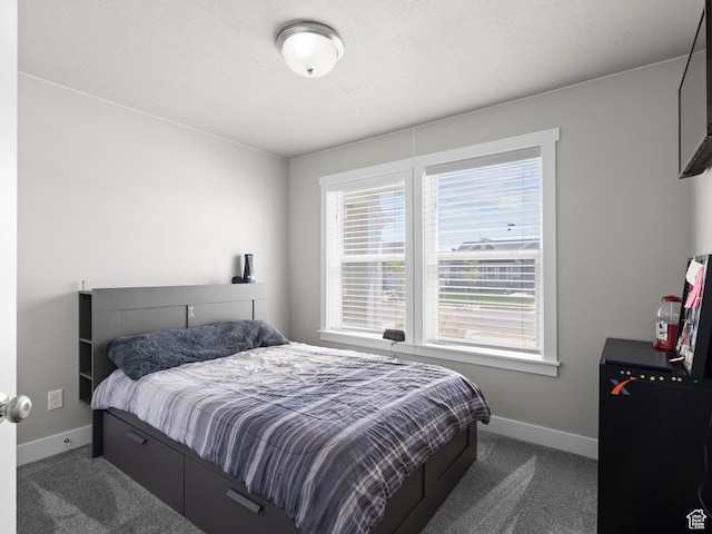 carpeted bedroom featuring baseboards