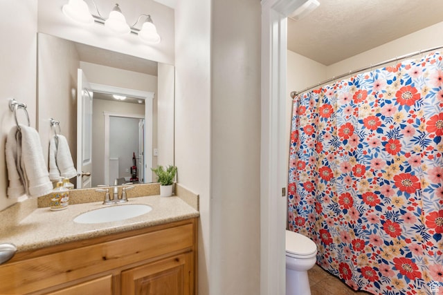 full bathroom with toilet, vanity, curtained shower, and tile patterned flooring