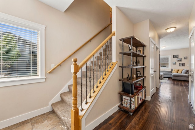 stairs featuring baseboards and wood finished floors