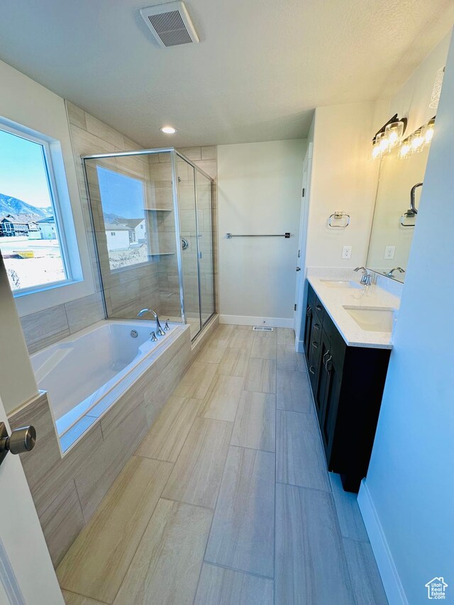 566 W 1860 N, Tooele, UT 84074 - bathroom with a bath, a stall shower, double vanity, and baseboards