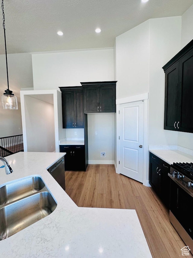 566 W 1860 N, Tooele, UT 84074 - kitchen with a sink, stainless steel appliances, light wood finished floors, dark cabinets, and recessed lighting