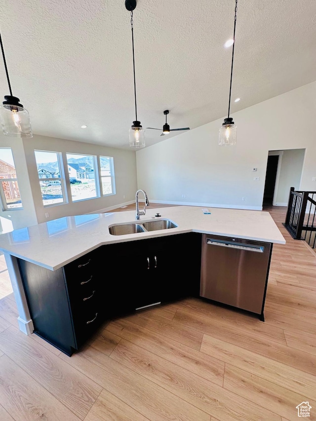 566 W 1860 N, Tooele, UT 84074 - kitchen with stainless steel dishwasher, a sink, a textured ceiling, light wood-style floors, and light countertops