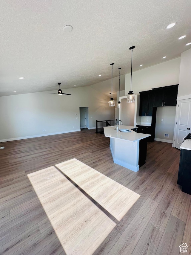 566 W 1860 N, Tooele, UT 84074 - kitchen with a sink, a textured ceiling, light countertops, open floor plan, and ceiling fan