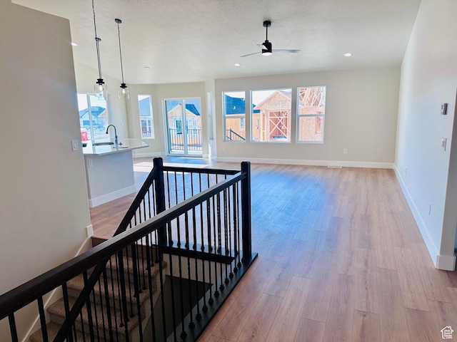 566 W 1860 N, Tooele, UT 84074 - hall with an upstairs landing, light wood-style flooring, baseboards, and recessed lighting