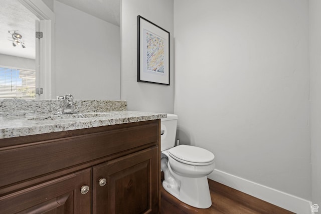2051 W 1080 N, Provo, UT 84604 - bathroom with wood finished floors, vanity, toilet, and baseboards