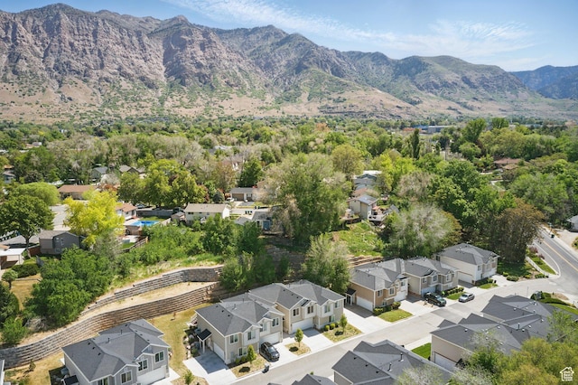 aerial view of property's location with nearby suburban area and a mountainous background