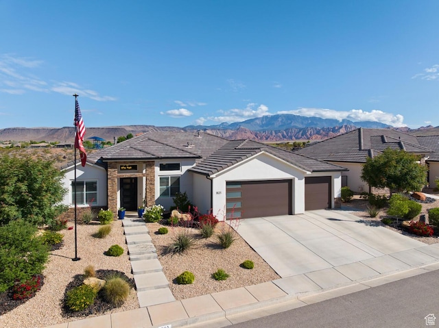921 N Camino Pico N, Washington, UT 84780 - view of front of house featuring an attached garage, stucco siding, a mountain view, and driveway
