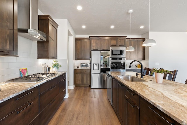 921 N Camino Pico N, Washington, UT 84780 - kitchen with a sink, wall chimney range hood, appliances with stainless steel finishes, dark wood-type flooring, and light stone countertops