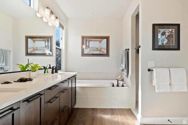 921 N Camino Pico N, Washington, UT 84780 - bathroom with wood finished floors, a garden tub, double vanity, and a shower