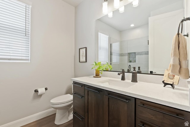 921 N Camino Pico N, Washington, UT 84780 - full bath with wood finished floors, a shower stall, toilet, baseboards, and vanity