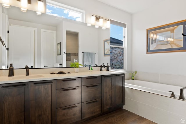 921 N Camino Pico N, Washington, UT 84780 - bathroom with a bath, double vanity, wood finished floors, and toilet
