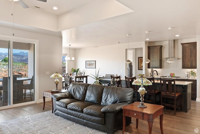 921 N Camino Pico N, Washington, UT 84780 - living area featuring wood finished floors, a ceiling fan, a chandelier, recessed lighting, and baseboards