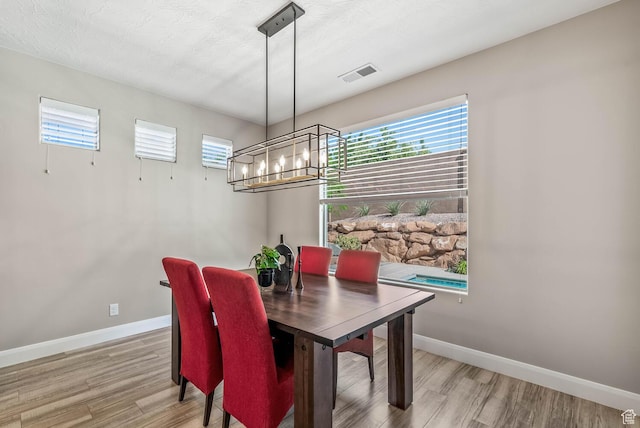 750 W 1860 N, Washington, UT 84780 - dining room featuring a chandelier, plenty of natural light, light wood finished floors, and baseboards