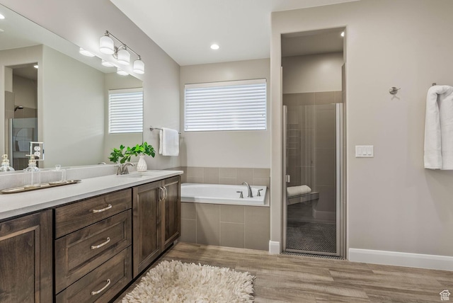 750 W 1860 N, Washington, UT 84780 - bathroom featuring wood finished floors, a stall shower, a garden tub, and vanity