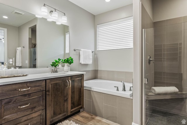 750 W 1860 N, Washington, UT 84780 - bathroom with a stall shower, a garden tub, vanity, wood finished floors, and recessed lighting
