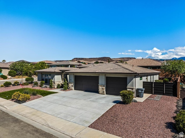 750 W 1860 N, Washington, UT 84780 - prairie-style home with an attached garage, driveway, stucco siding, fence, and stone siding