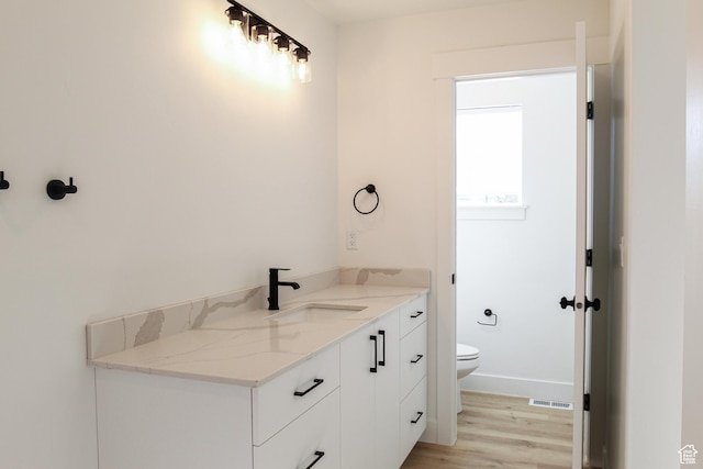 561 N 300 W, Smithfield, UT 84335 - bathroom with toilet, wood finished floors, vanity, and baseboards