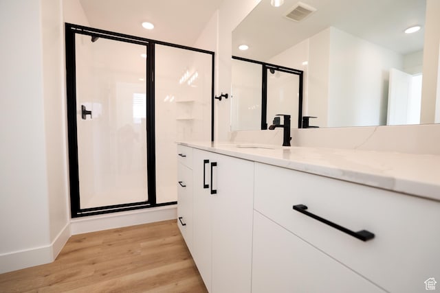 561 N 300 W, Smithfield, UT 84335 - bathroom featuring wood finished floors, a shower stall, vanity, and recessed lighting