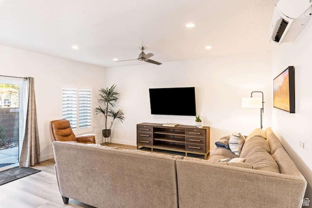 living area with light wood-type flooring, a ceiling fan, recessed lighting, and baseboards