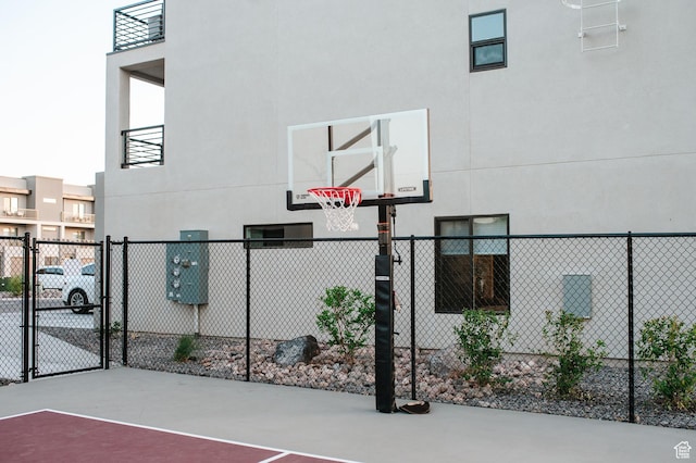 view of sport court with a gate, fence, and community basketball court