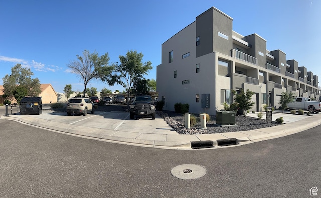view of building exterior featuring uncovered parking