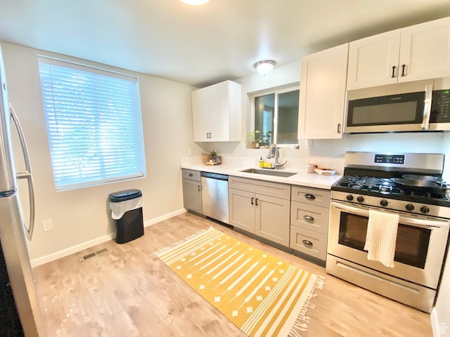 600 S Main St, Kaysville, UT 84037 - kitchen with appliances with stainless steel finishes, a sink, light wood finished floors, and light countertops