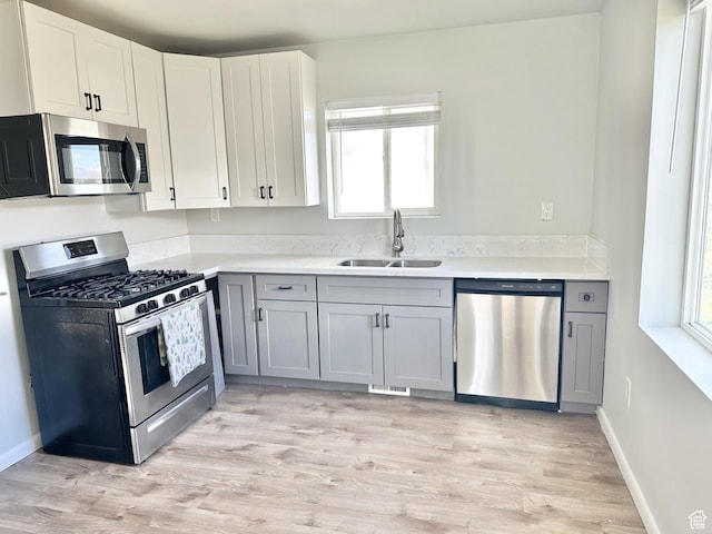 600 S Main St, Kaysville, UT 84037 - kitchen with appliances with stainless steel finishes, a sink, plenty of natural light, and light countertops